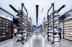 the inside of a shoe store filled with lots of shelves full of shoes and sneakers