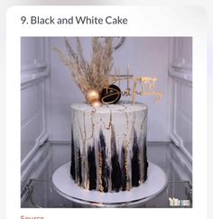 a white and black cake with gold decorations