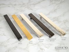 four different types of handles on a marble counter top