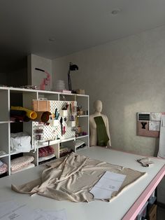 a sewing studio with mannequins and fabric on the table