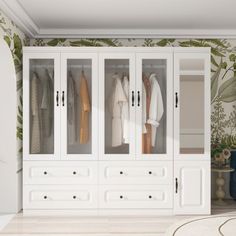 a white closet with lots of clothes hanging on it's doors, and a rug in front of it