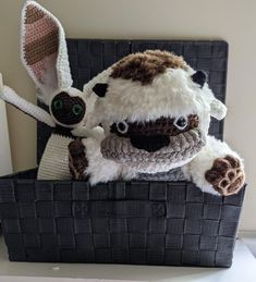 two stuffed animals are sitting in a basket