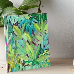 a painting of tropical plants on a table next to a plant potted in a vase