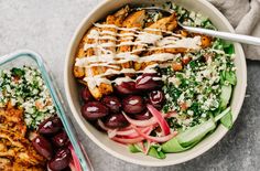 a bowl filled with salad and dressing next to a glass container full of chicken breast