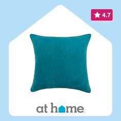 a blue pillow with the words at home on it and an image of a house