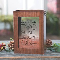 a wooden box with a sign that says and the two shall become one