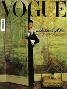 a magazine cover with a woman standing in front of a painting and a dog laying on the floor