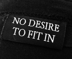 there is a patch on the back of a shirt that says no desire to fit in