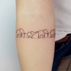 a line drawing of elephants on the arm