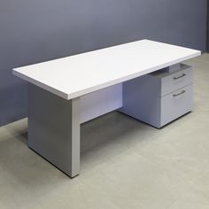 an office desk with two drawers on each side and a grey wall in the background