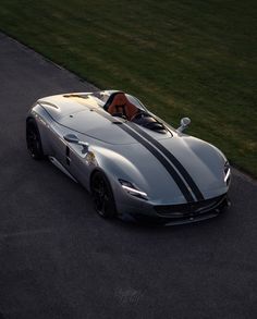 a silver sports car driving down the road