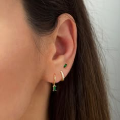 "** This listing is for the emerald hoop earrings (as seen in the 2nd photo). Sold individually (1 hoop) or as a pair (2 hoops). Simple and beautiful, these tiny hoop earrings are adorned with a dainty emerald green baguette charm. Layer these versatile huggie hoops with other delicate earrings to create your favourite ear stack. * D E T A I L S * ∙ Material: .925 Sterling Silver or 18K Gold Plated over .925 Sterling Silver ∙ Stone: Emerald Green Zirconia ∙ Dimensions: Hoop diameter: 11mm // Bag Cute Earrings Combinations, Emerald Dainty Jewelry, Stone Hoops Earrings, Dainty Jewelry Green, Ear Piercings 2 Ears, Gold And Green Earring Set, Earring Stacks Double, Earrings Double Lobe, Good Huggie Earrings