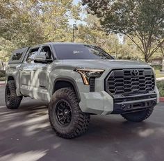 a gray truck is parked on the street