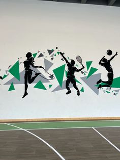 a tennis player jumping up to hit the ball with his racket on an indoor court