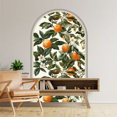 an orange tree wallpaper mural in a living room with a chair and bookcase