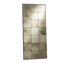 a mirror that is sitting on top of a white wall and has squares in it