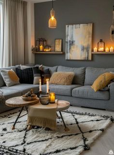 a living room filled with lots of furniture and candles on top of the coffee table