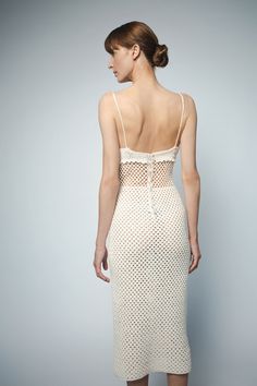 Easily transition from a casual beachside gathering to a rooftop oasis in the relaxed glamour of our 100% cotton hand crochet dress, Viola. In colors inspired by the soothing neutrals of summer, the dress features adjustable spaghetti straps, flattering triangle cups, and an open weave midriff that gives a glimpse of skin. The Viola is accented with scalloped details under the bust and finished with beautiful Italian pearl buttons down the center back placket. A true celebration of the feminine, Rooftop Oasis, Relaxed Glamour, Wool Clothes, Crochet Collection, Crochet Business, Knitting Blogs, Crochet Dresses, Body Conscious, Strappy Dress