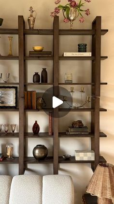 a living room filled with furniture and shelves