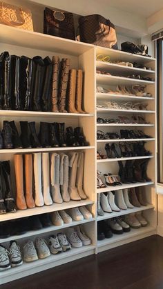 a closet filled with lots of shoes next to a window