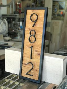 a wooden sign with the number twenty nine on it in front of a workbench