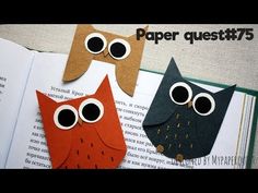 two owls made out of paper sitting on top of an open book