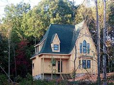 a house in the woods surrounded by trees