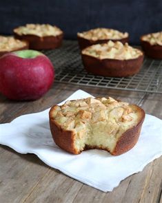 an apple muffin on a napkin next to some apples