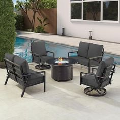 an outdoor fire pit with four chairs around it