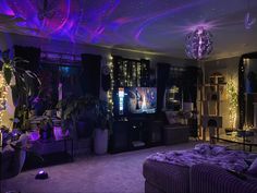 a living room filled with furniture and lots of purple lights on the ceiling above it