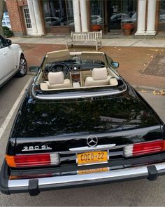 a black convertible car parked in front of a building