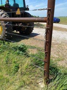 a tractor behind a barbed wire fence