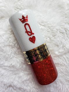 a red and white toilet paper roll with the word love on it sitting on top of a furry surface