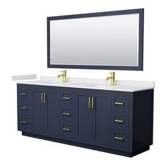 a bathroom vanity with two sinks and a large mirror on the wall above it is shown