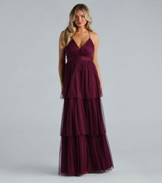 Look sophisticated and dreamy in the Joselyn formal long dress as a bridesmaid or attending a dance! She features adjustable spaghetti straps, a flattering V-neckline, and a delicate crisscross back. The tiered, ruffled A-line silhouette gives a subtly voluminous look, while the floor-length mesh fabric adds a touch of opulence. Complete the look with a statement ring set and heels.Fit & FeaturesSleeveless V-neckline, adjustable spaghetti strapsCrisscross, back zipper and hook-eye closureTiered ruffled A-line silhouetteFloor-length hemMesh fabric, stretchy knit liningPasties recommendedRuns true to size Maroon Tulle Dress, Long Winter Formal Dresses For Teens, Egypt Wedding, Formal Long Dress, Plum Bridesmaid Dresses, Red Bridesmaid, Sequin Dress Party, Look Sophisticated, Fall Bridesmaid Dresses