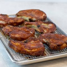 some food is sitting on a cooling rack and ready to be cooked in the oven