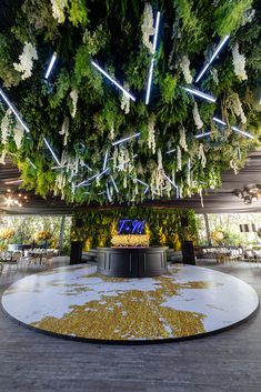 an indoor wedding venue decorated with flowers and greenery