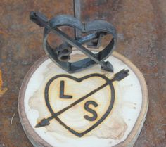 a piece of wood that has some type of object on it with the word love and two crossed wrenches