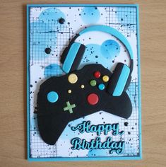 a birthday card with a video game controller on the front and happy birthday written in blue