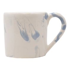 a blue and white coffee cup with music notes on it