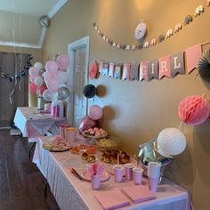 a table filled with pink and white desserts