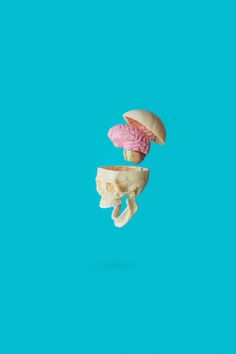 two halves of a hamburger and a banana split in half on a blue background, with one being eaten by the other