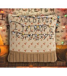 a pillow that has been decorated with letters and numbers