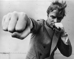 a black and white photo of a man pointing his finger