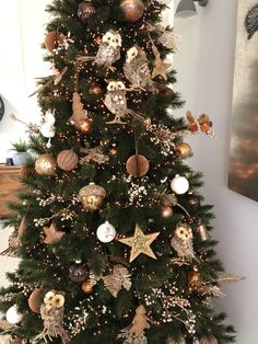 a christmas tree decorated with gold and silver ornaments