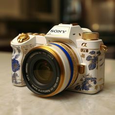 a white and blue camera sitting on top of a table