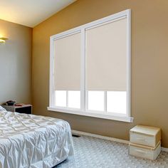 a bedroom with a bed, nightstand and window in the corner that has no blinds