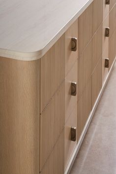 a large wooden cabinet sitting next to a white counter