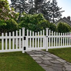 a white picket fence in front of a house