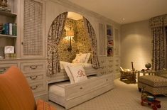 a bedroom with a bed, dressers and shelves in the corner is decorated in gold and white